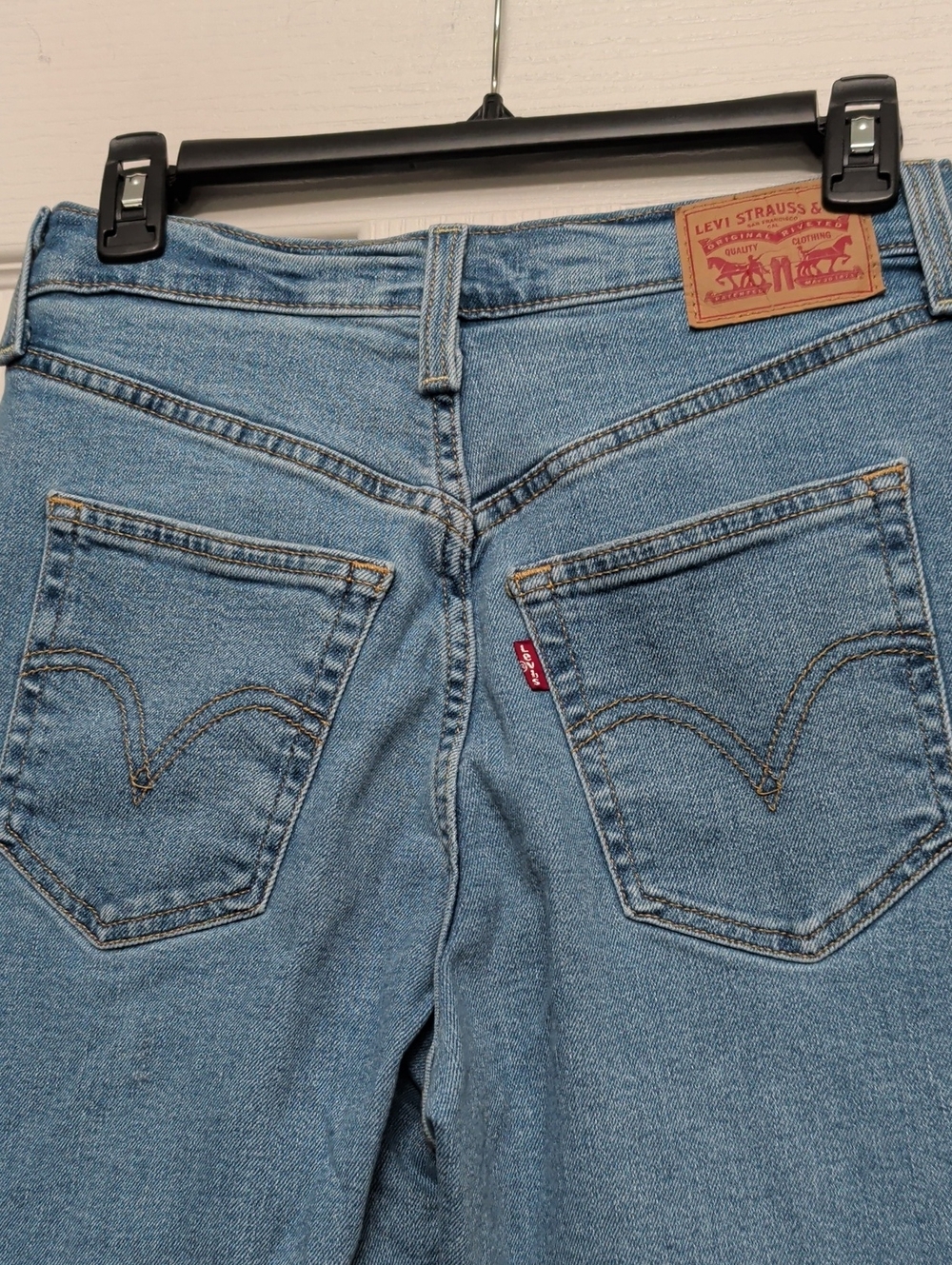 Levis Women's Light Blue Jeans Size 27 Ripped Knees Raw Hem Ribcage straight Leg